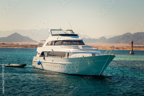 Yacht in the sea around the island. Sailboat in red sea. Yachting. Sailing. Travel Concept. Summertime Vacation © Irina