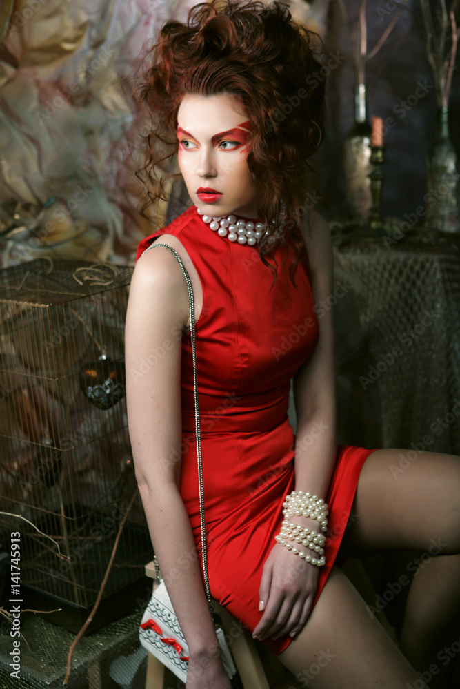 Fototapeta premium young woman with creative visage wearing red dress