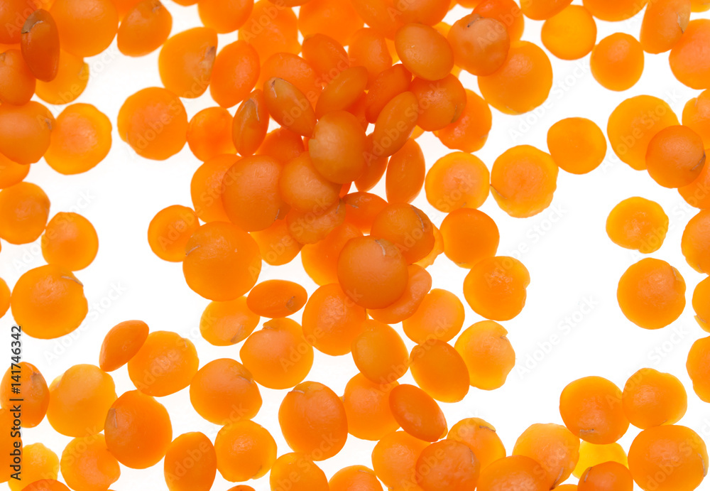 red lentils on a white background red lentils on a white background