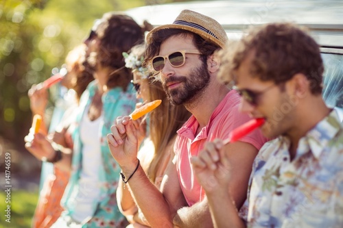 Group of friends eating ice lolly
