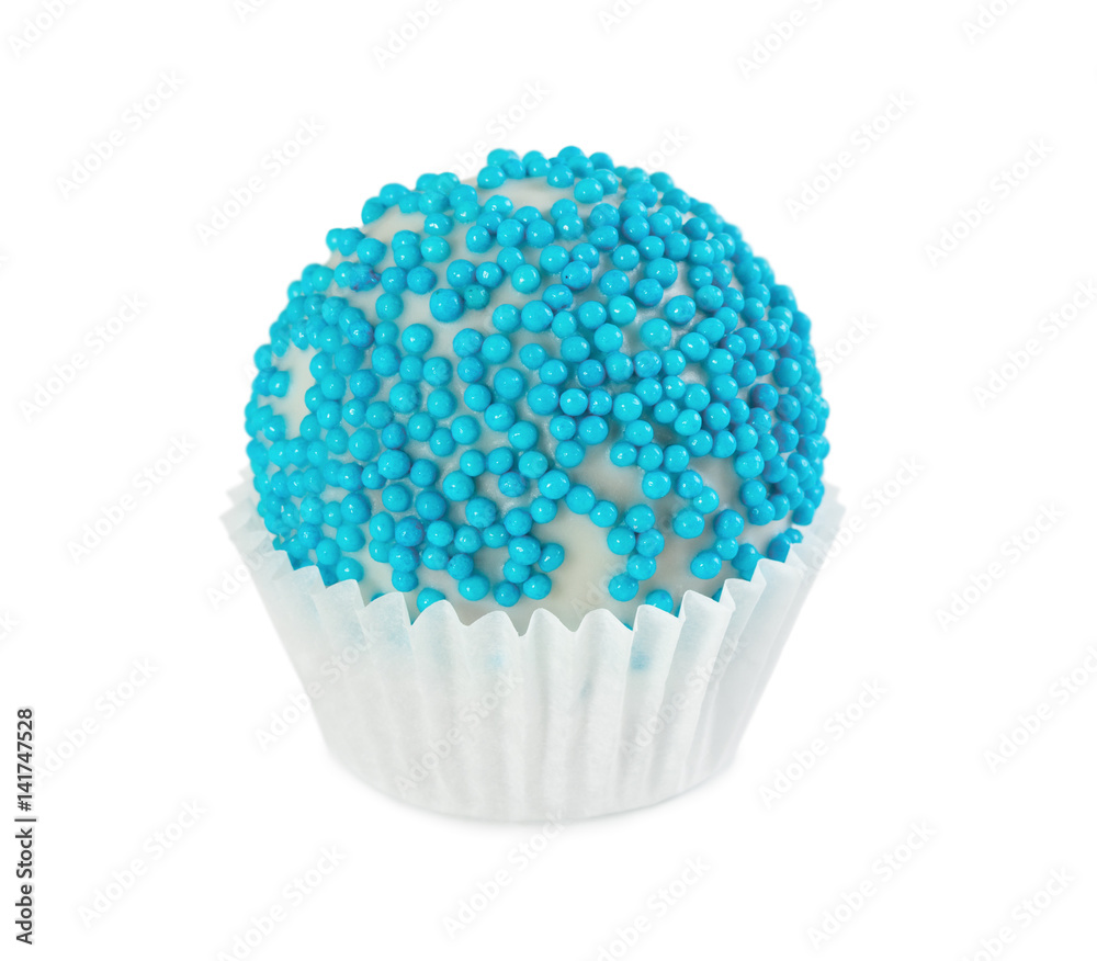 Cake ball in white glaze with blue sprinkles in paper form Cake ball in white glaze with blue sprinkles in paper form
