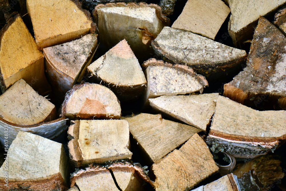 Natural wooden background, closeup of chopped firewood. Firewood stacked and prepared for winter Pile of wood logs. Chopped firewood on a stack.