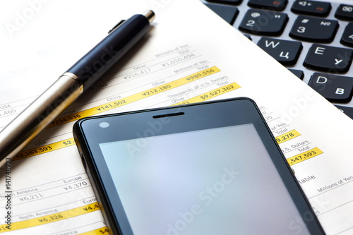 Smartphone, keyboard and financial calculations photo