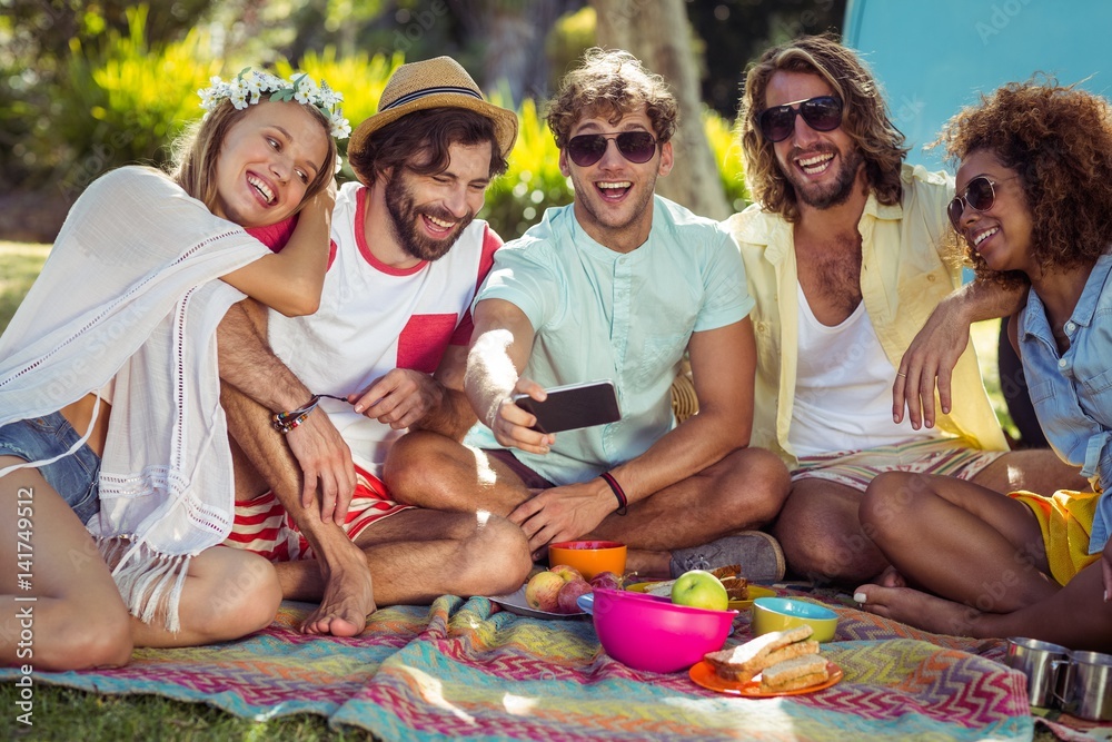 Group of happy friend taking a selfie in park Group of happy friend taking a selfie in park