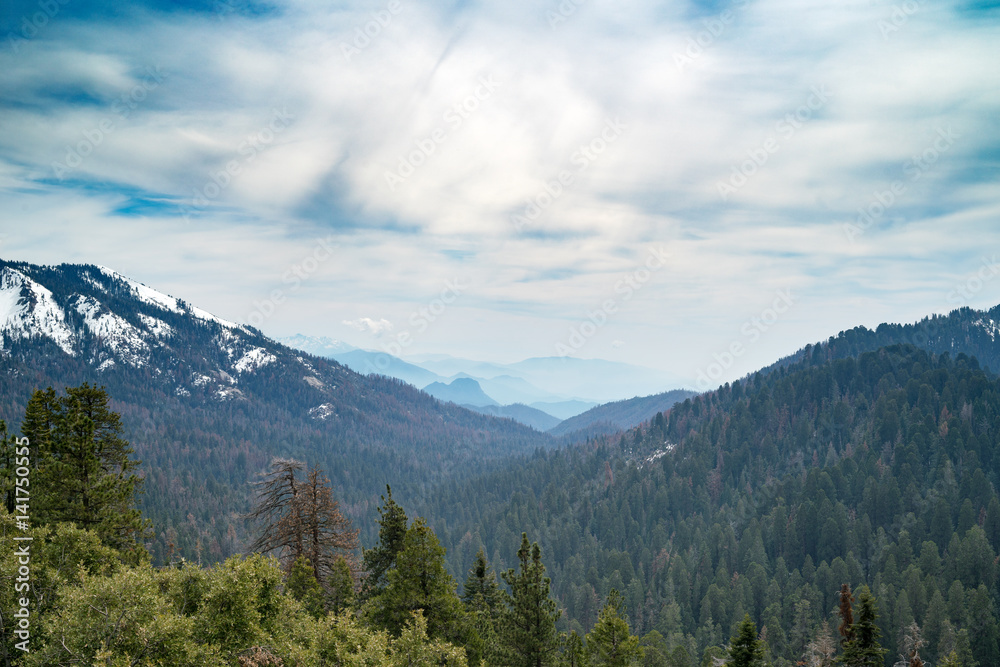 Landscape of Sequoia National park in spring with mountain peaks covered by snow