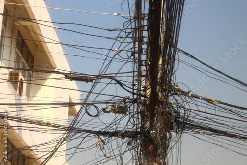 Power poles and many telephone lines in the communication era without borders.