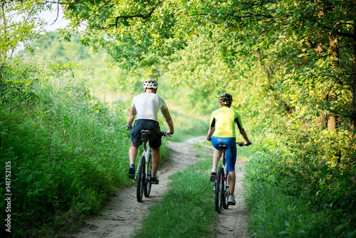 Man and woman are bicycles.