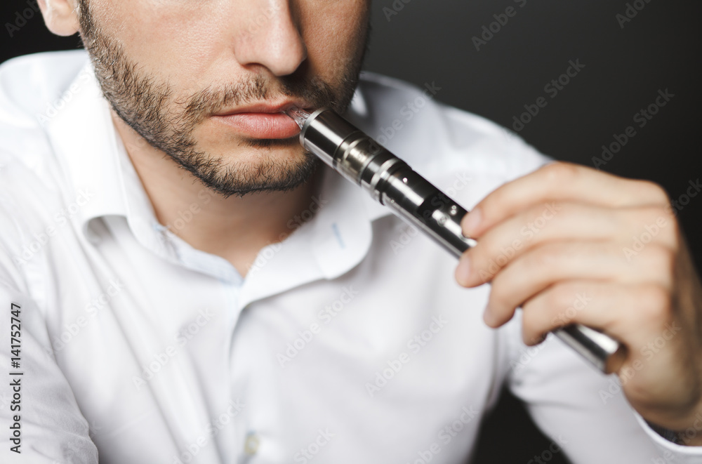Man with concealed identity smoking a controversial vape Man with concealed identity smoking a controversial vape