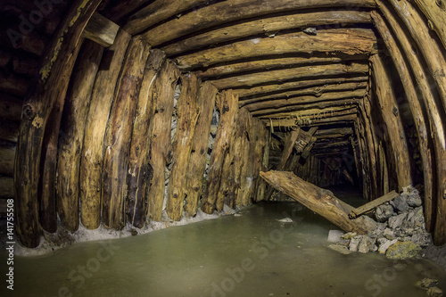 Wooden support in the  аbandoned mine photo