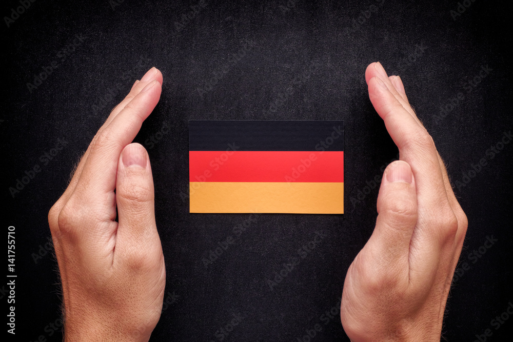 Hands Protecting German Flag Hands Protecting German Flag