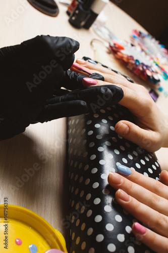 Woman hand made blue and pink manicure step by step photo