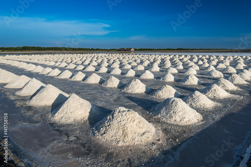 salt piles in saline under blue sky