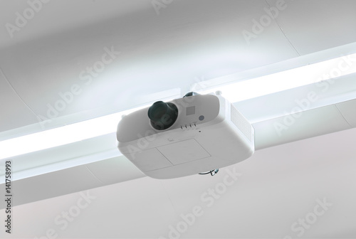 A white overhead projector on ceiling indoors. photo