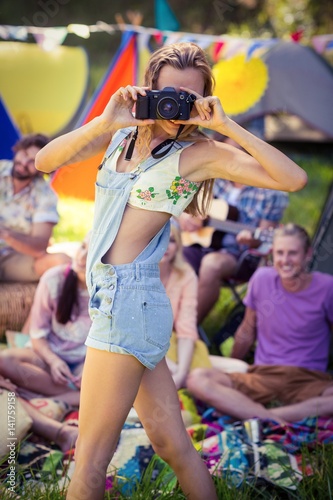 Woman taking a picture at campsite