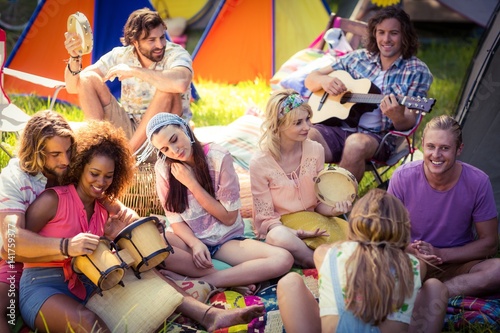 Group of friends having fun together at campsite