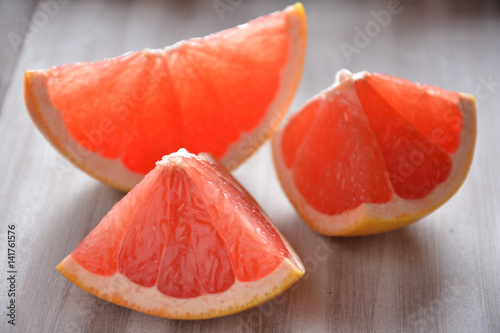 Pink grapefruit slices on a wooden board