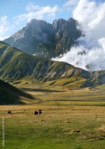 The Gransasso Standing tall over the valley at his feet invaded by the peace and tranquility of the mountain life. photo