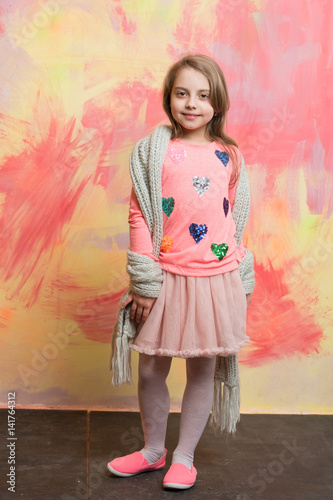 small happy baby girl in pink skirt, scarf and shirt © be free