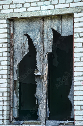 fragments of broken glass of a window in an abandoned house photo