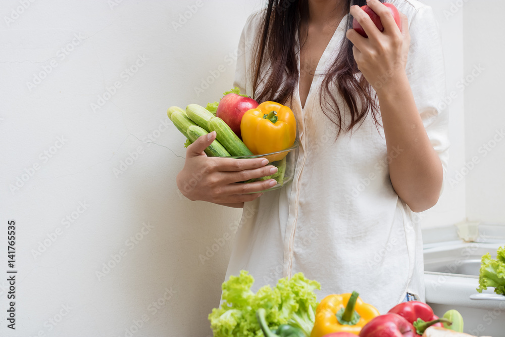 Woman with fruits and vegetables in the kitchen. Woman with fruits and vegetables in the kitchen.