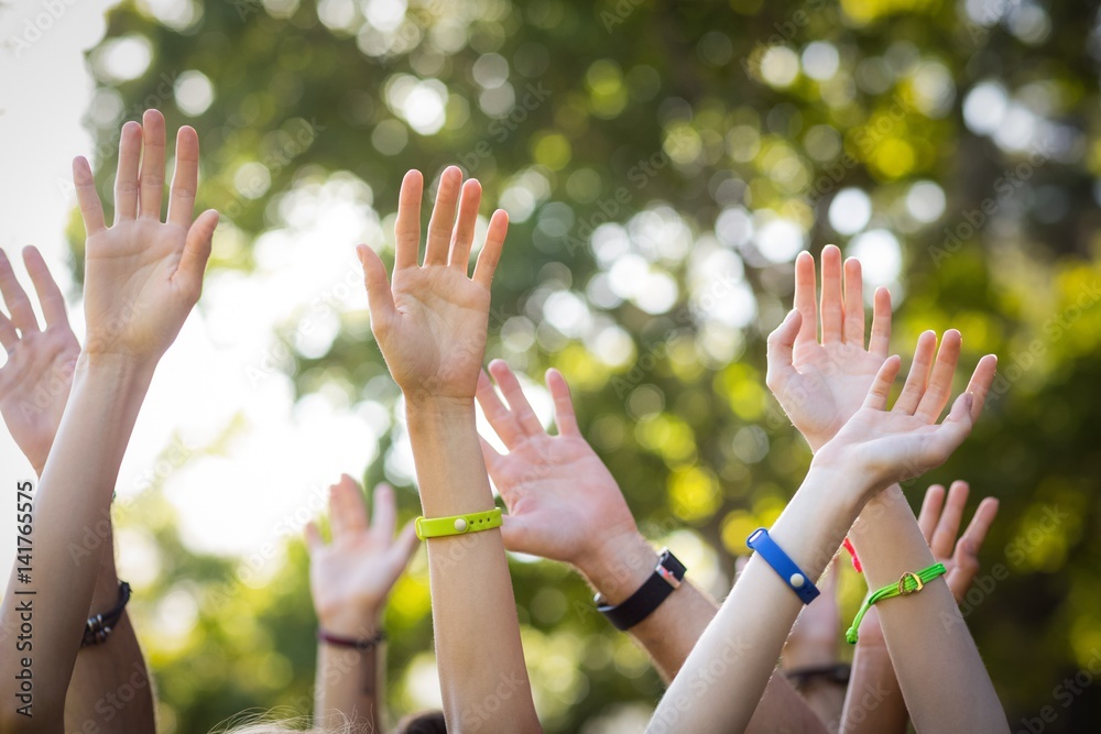 Friends raising their hands while dancing at music festival Friends raising their hands while dancing at music festival