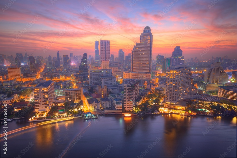 Aerial panorama of Bangkok in morning twilight, with rosy clouds in the sky, lights of boats on Chao Phraya River & modern skyscrapers by riverside ~ Sunrise scenery of Bangkok City in bird's eye view