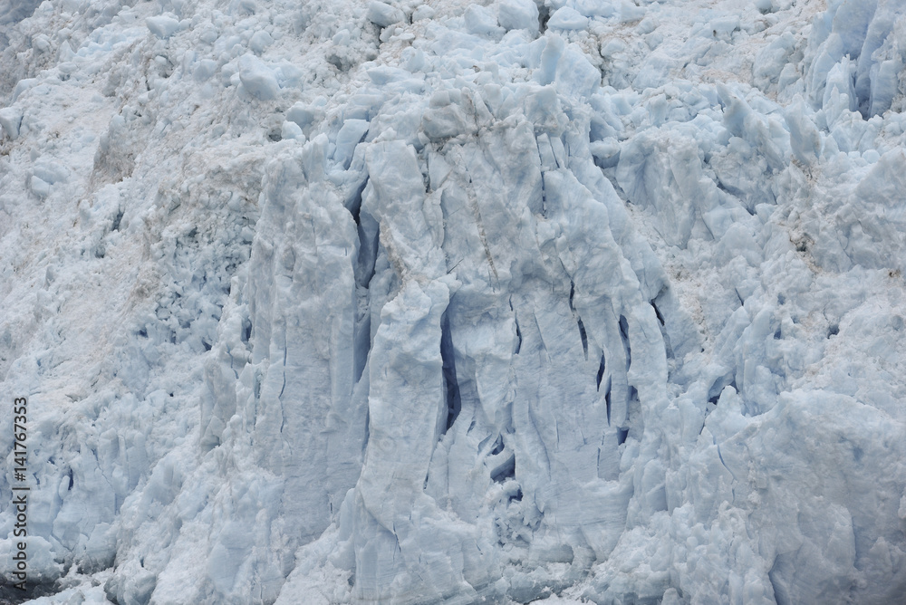 front of a glacier structured with cracks front of a glacier structured with cracks