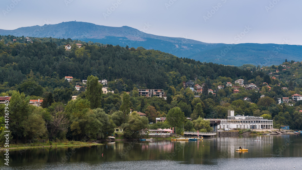 Houses on the hillside in front of the lake Pancharevo. Sofia, Bulgaria