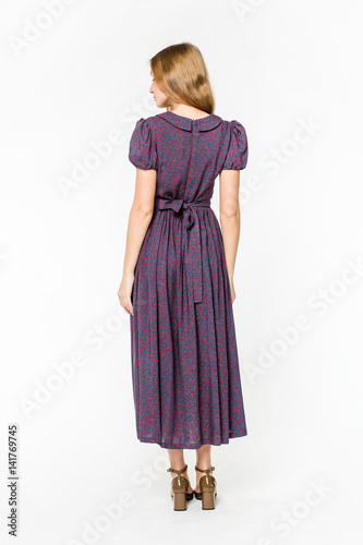 Young elegant female in light summer dress, over white background