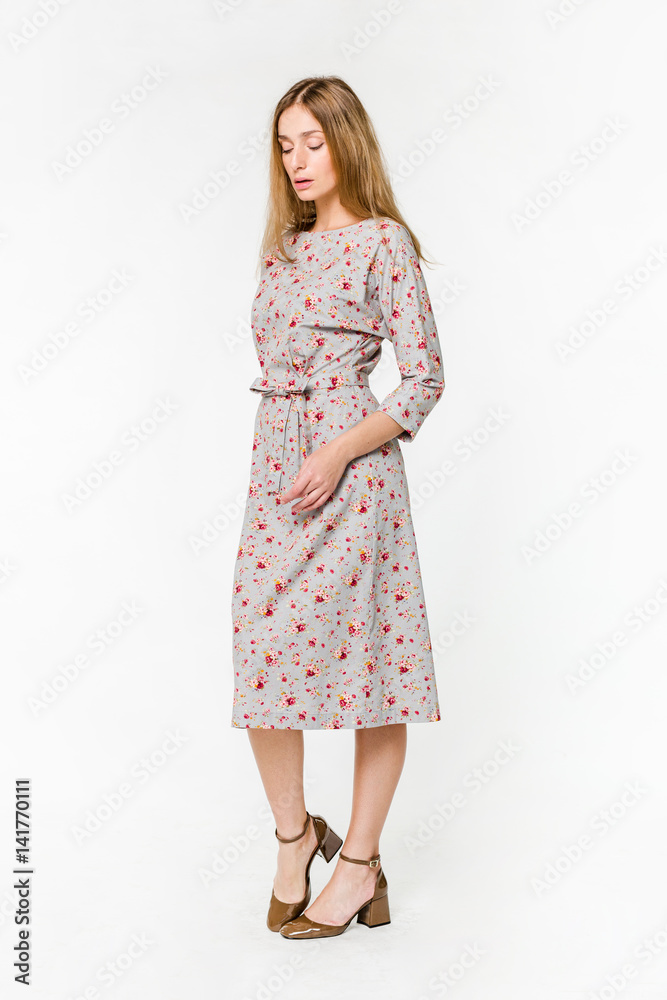 Young elegant female in light summer dress, over white background Young elegant female in light summer dress, over white background