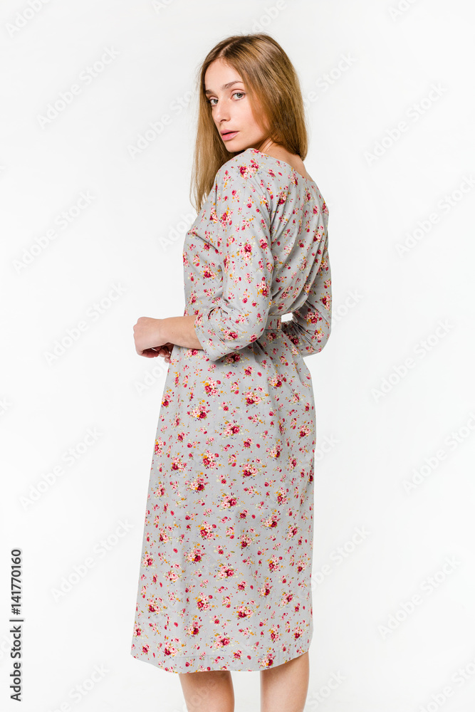 Young elegant female in light summer dress, over white background Young elegant female in light summer dress, over white background