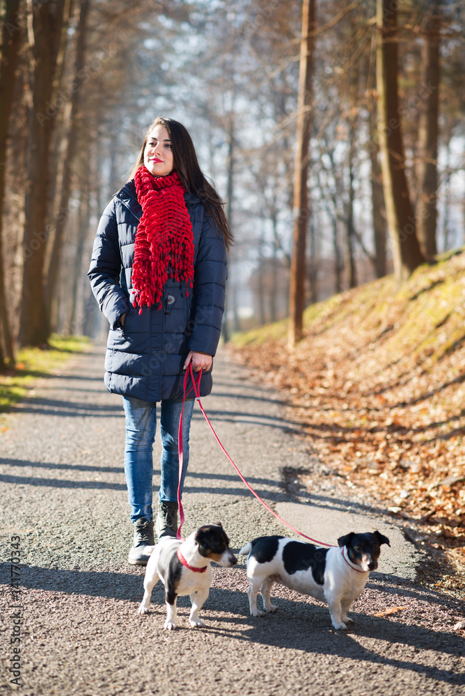 Beautiful and happy woman enjoying in park with her dogs Beautiful and happy woman enjoying in park with her dogs