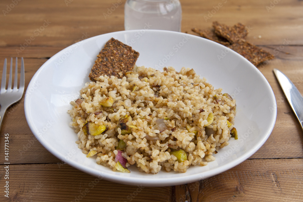 rice with vegetables dish in a wooden background with crackers and lemonade rice with vegetables dish in a wooden background with crackers and lemonade