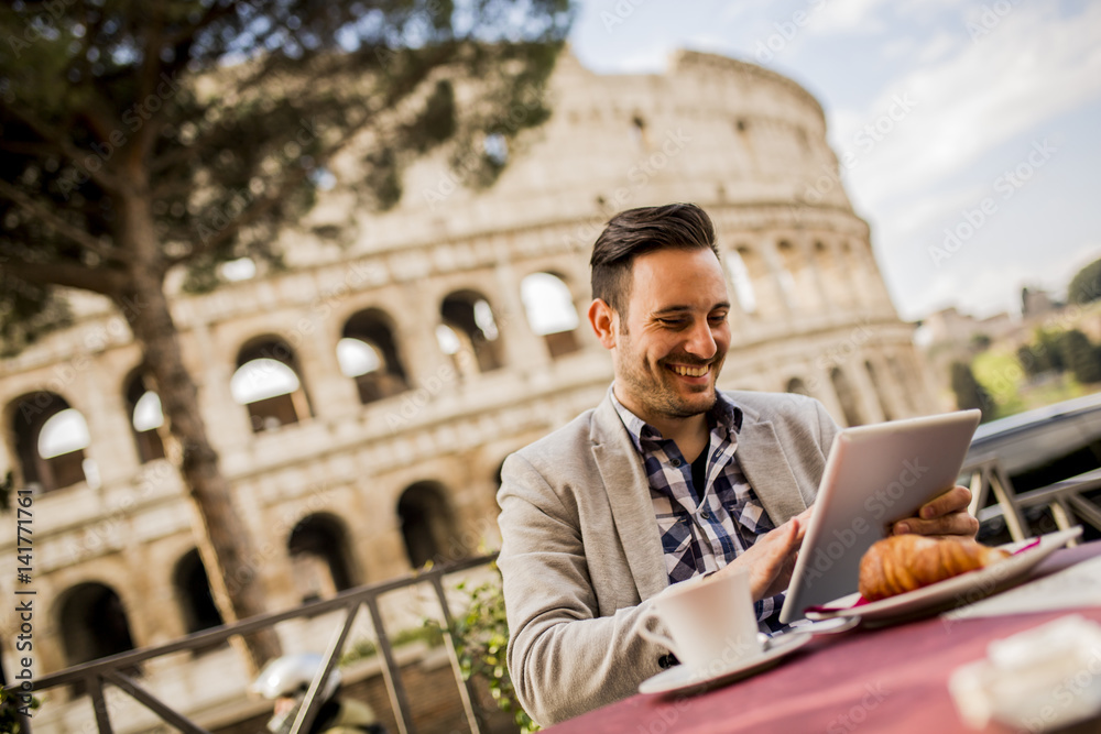 Young man sitting and having a cup of coffee in Rome, Italy Young man sitting and having a cup of coffee in Rome, Italy
