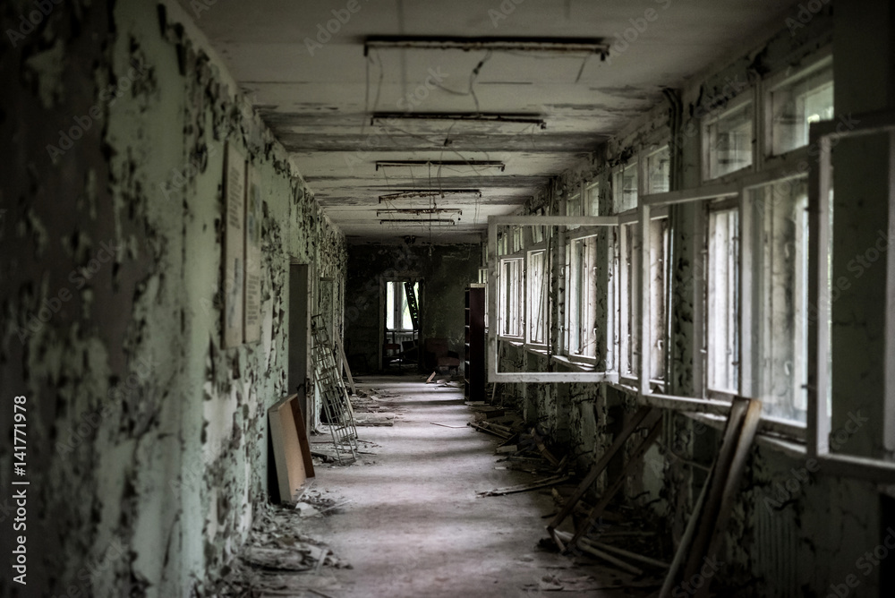 school room with turned chairs and opened window frames in Pripyat, Chernobyl, Ukraine