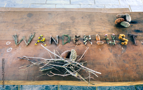 View from above of wanderlust word made with natural objects over wooden table
