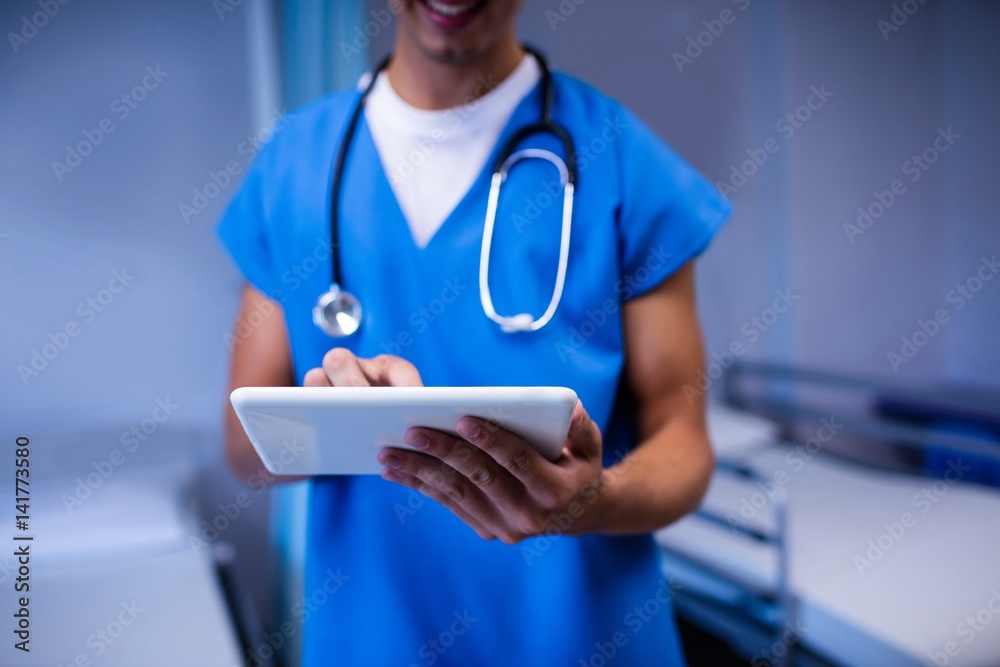 Doctor using digital tablet in ward at hospital Doctor using digital tablet in ward at hospital