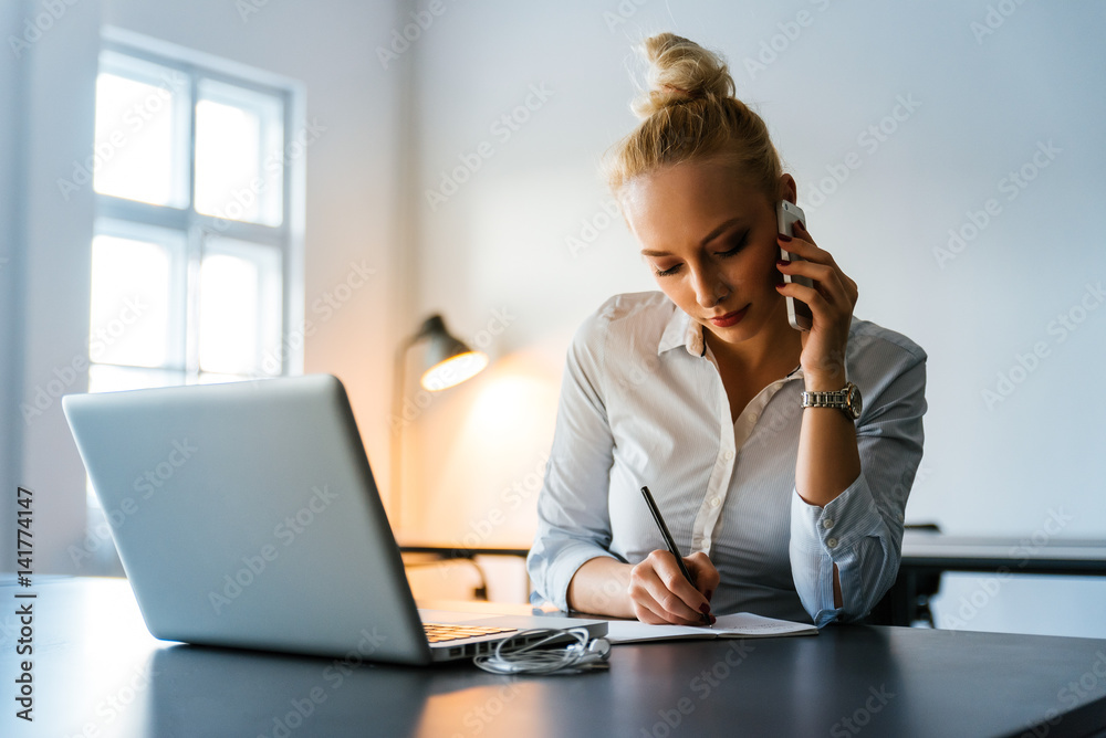 Attractive businesswoman working in an office Attractive businesswoman working in an office