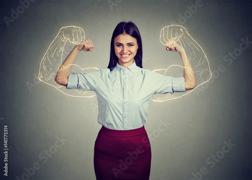 Powerful confident woman flexing her muscles. photo