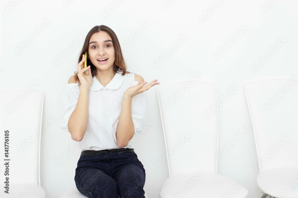Young business woman sitting on chair and using mobile phone Young business woman sitting on chair and using mobile phone