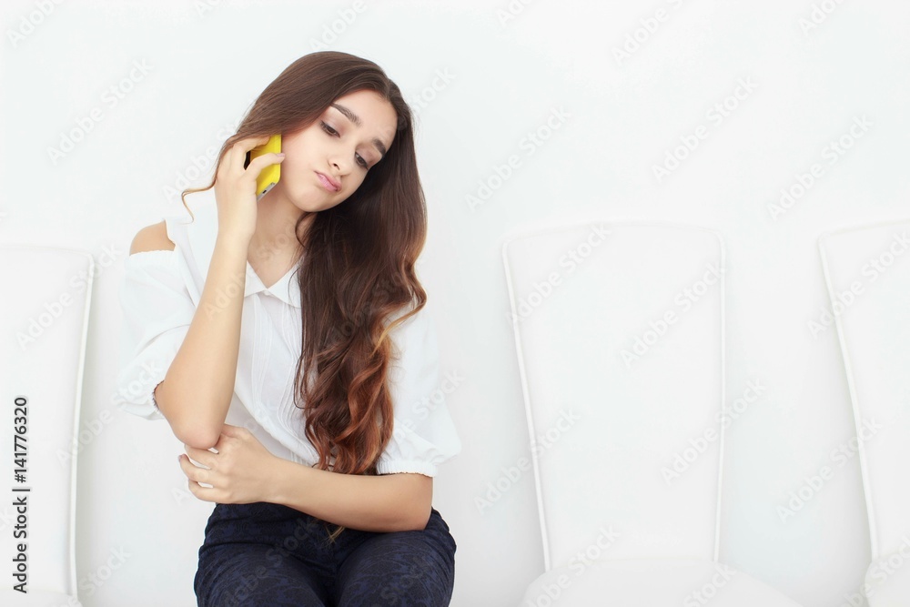 Young business woman sitting on chair and using mobile phone Young business woman sitting on chair and using mobile phone