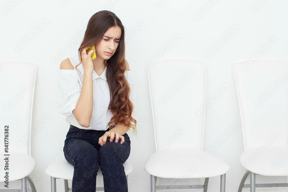 Young business woman sitting on chair and using mobile phone Young business woman sitting on chair and using mobile phone