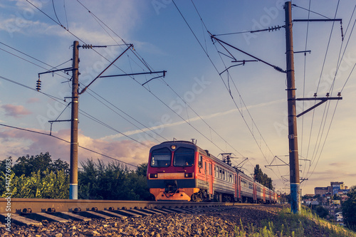 Modern passenger train on the background of blue and purple sky, copy space