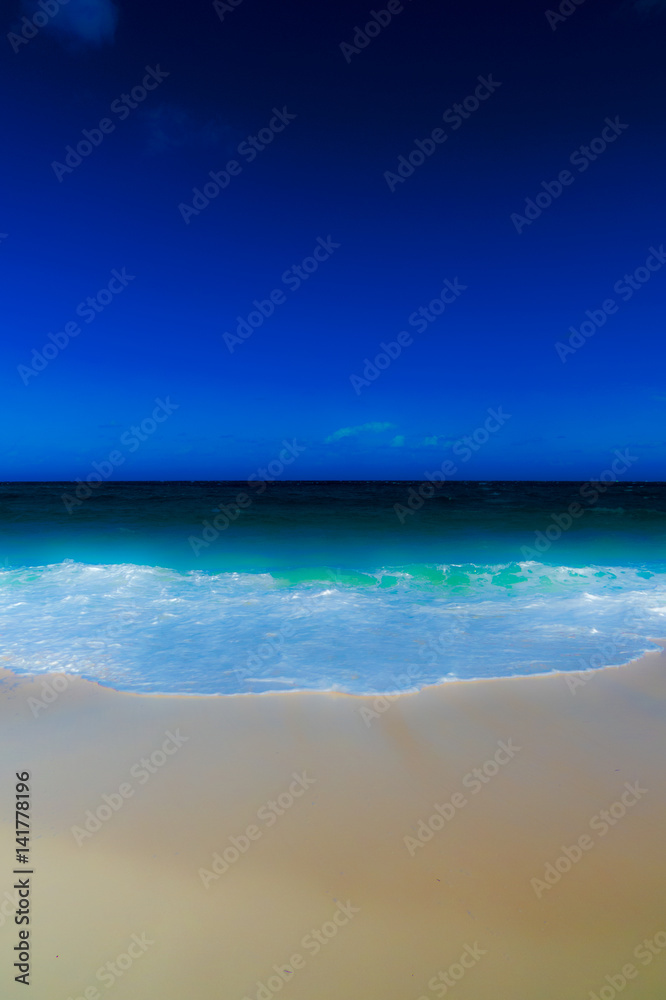 An abstract vertical photo of a tropical beach and the ocean with a blurry effect. New Providence, Nassau, Bahamas.