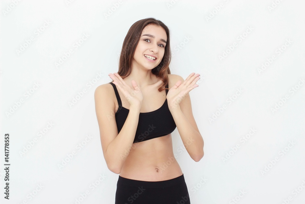 Beautiful girl in black top on white background shows emotion Beautiful girl in black top on white background shows emotion