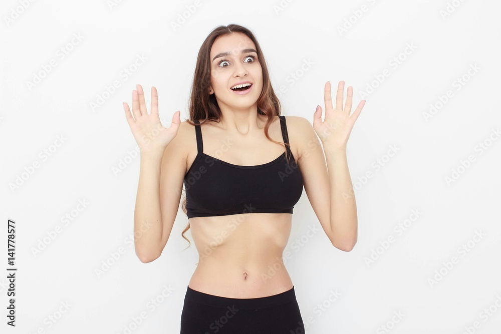 Beautiful girl in black top on white background shows emotion Beautiful girl in black top on white background shows emotion