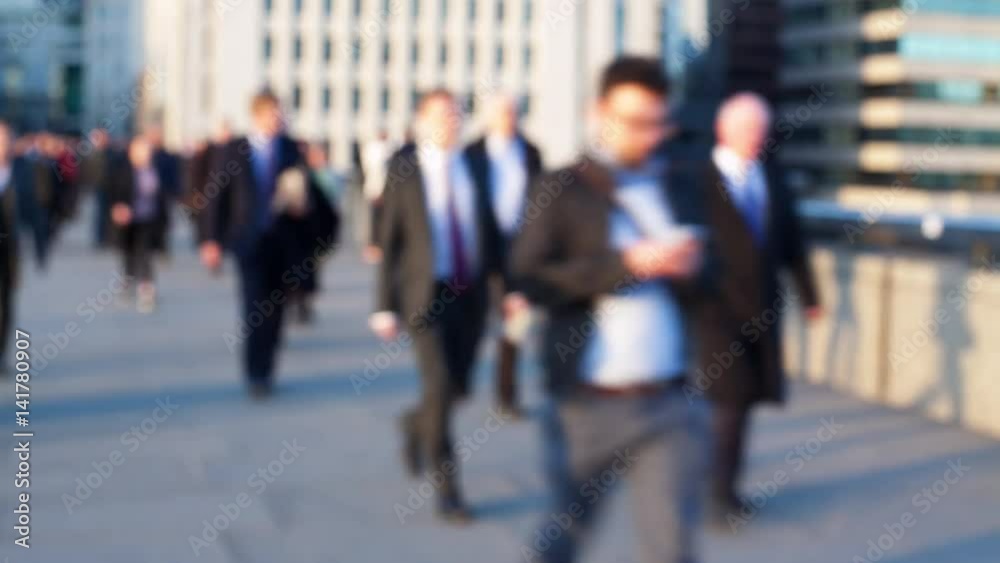 Defocussed time-lapse of commuters on London Bridge, London, England.