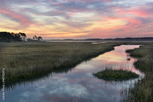 Clouds Refecting in Water of Salt Marsh at Sunrise.