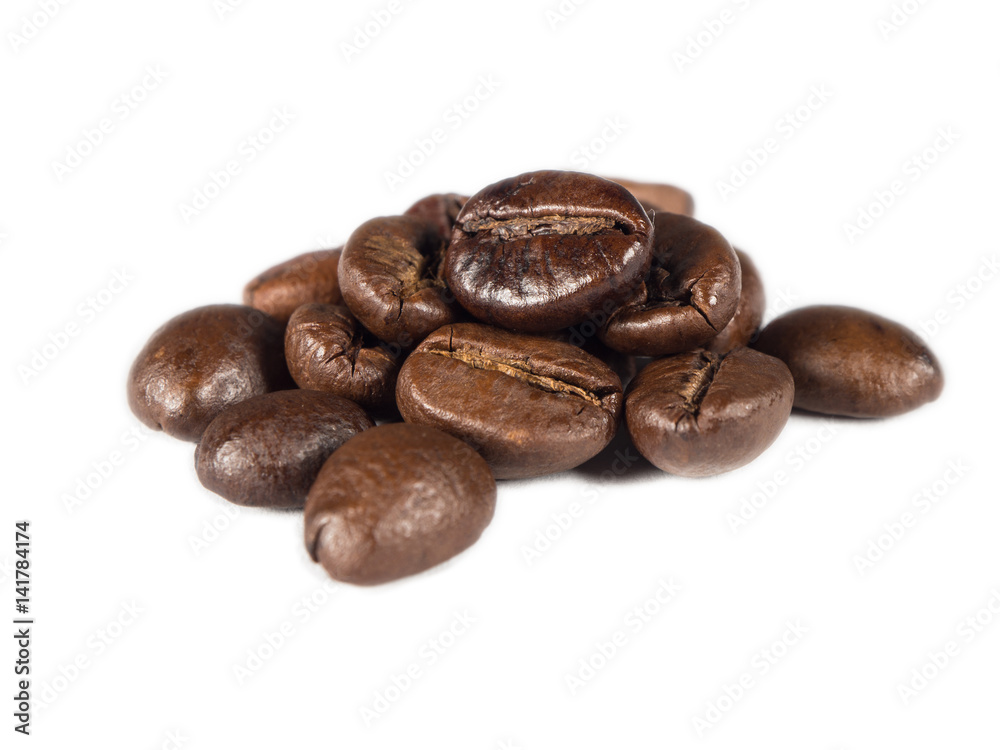 Roasted coffee grains on white isolated background from close up view Roasted coffee grains on white isolated background from close up view