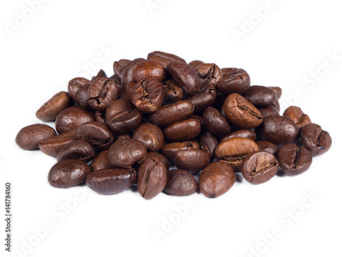 Roasted coffee grains on white isolated background from close up view